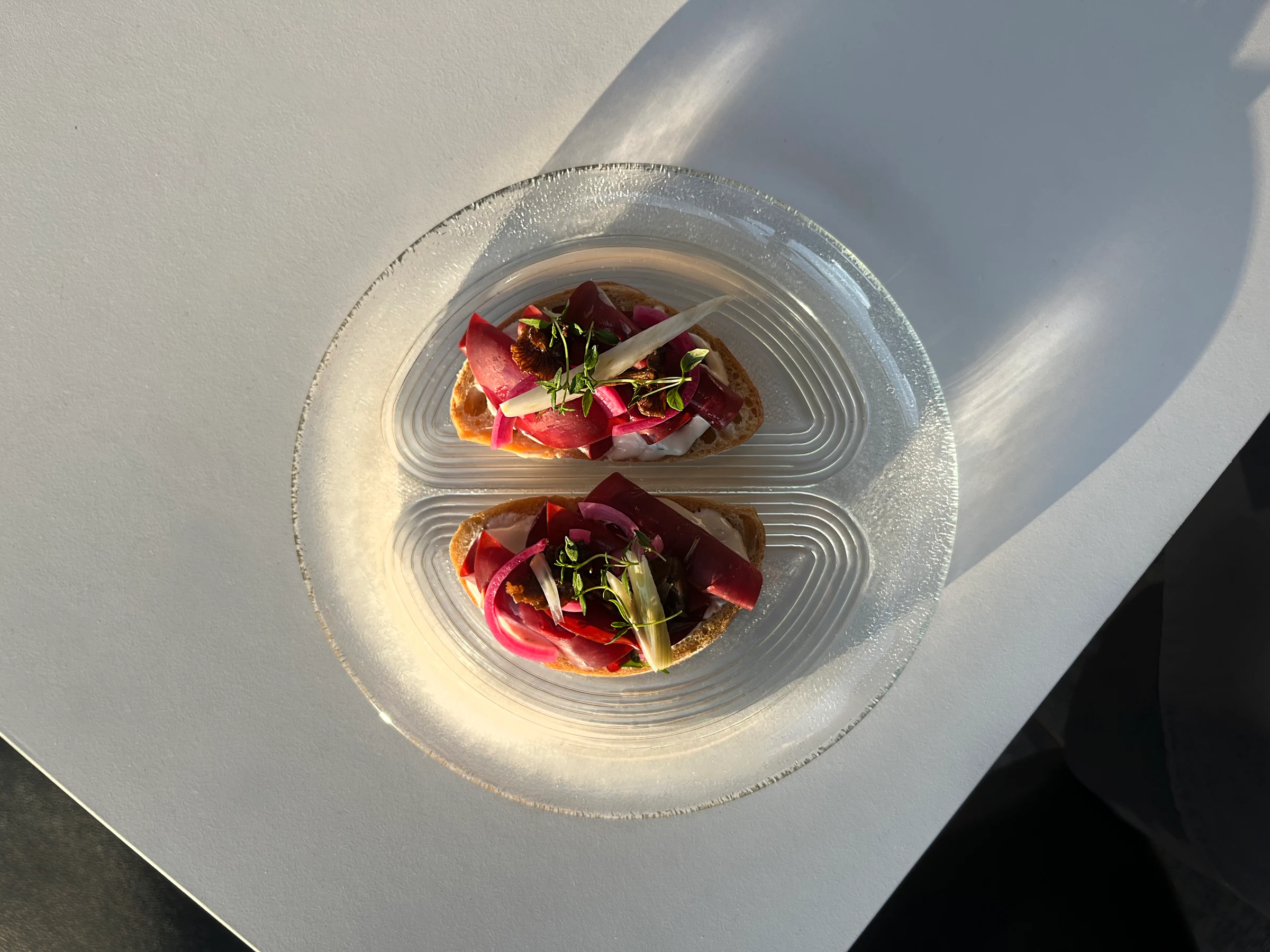 Nöösin leipäannokset lasilautasella auringonvalossa